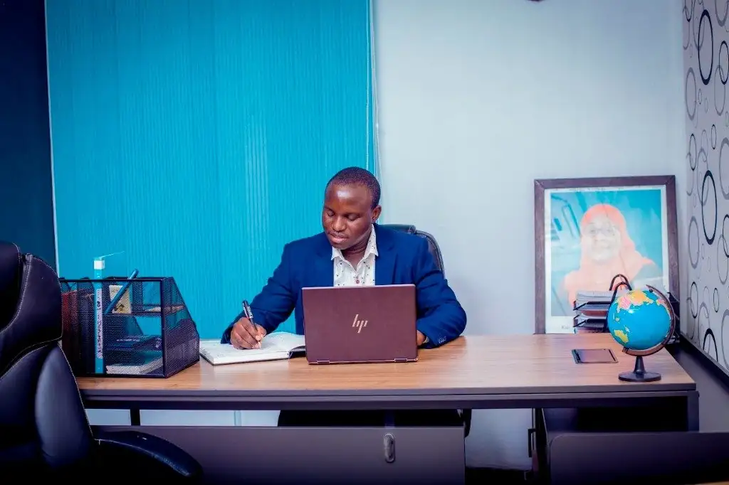 Zatra Consultants adviser reviewing a client file at the Dar es Salaam desk.
